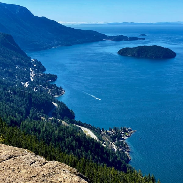 Very blue ocean, shoreline, islands and roads seen from above.