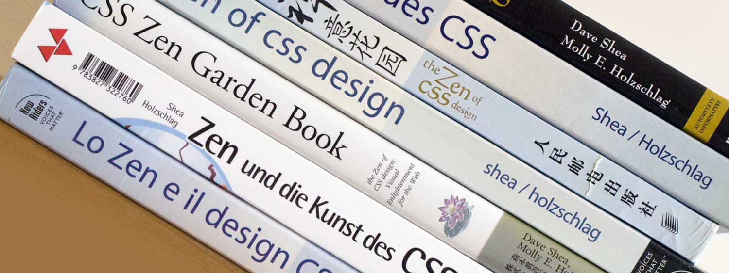 Tilted stack of spines of the same book translated into multiple languages